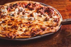 Rocco’s Little Chicago Pizzeria signature dishes  Chicago-Style Deep Dish Pizza (various toppings), Thin Crust Pizza, Italian Beef Sandwich, Wings, Garlic Bread with Cheese.